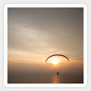 Paragliding over the ocean while golden sunset Magnet